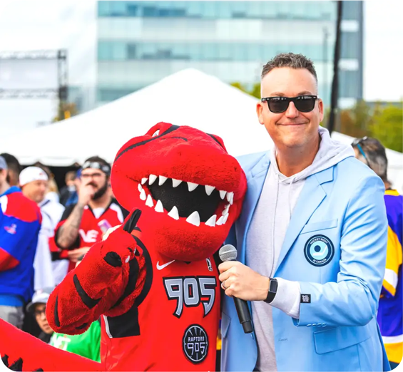Stripes, the Raptors 905 mascot, and a man in Hockey Night in Canada blazer give the thumbs up.